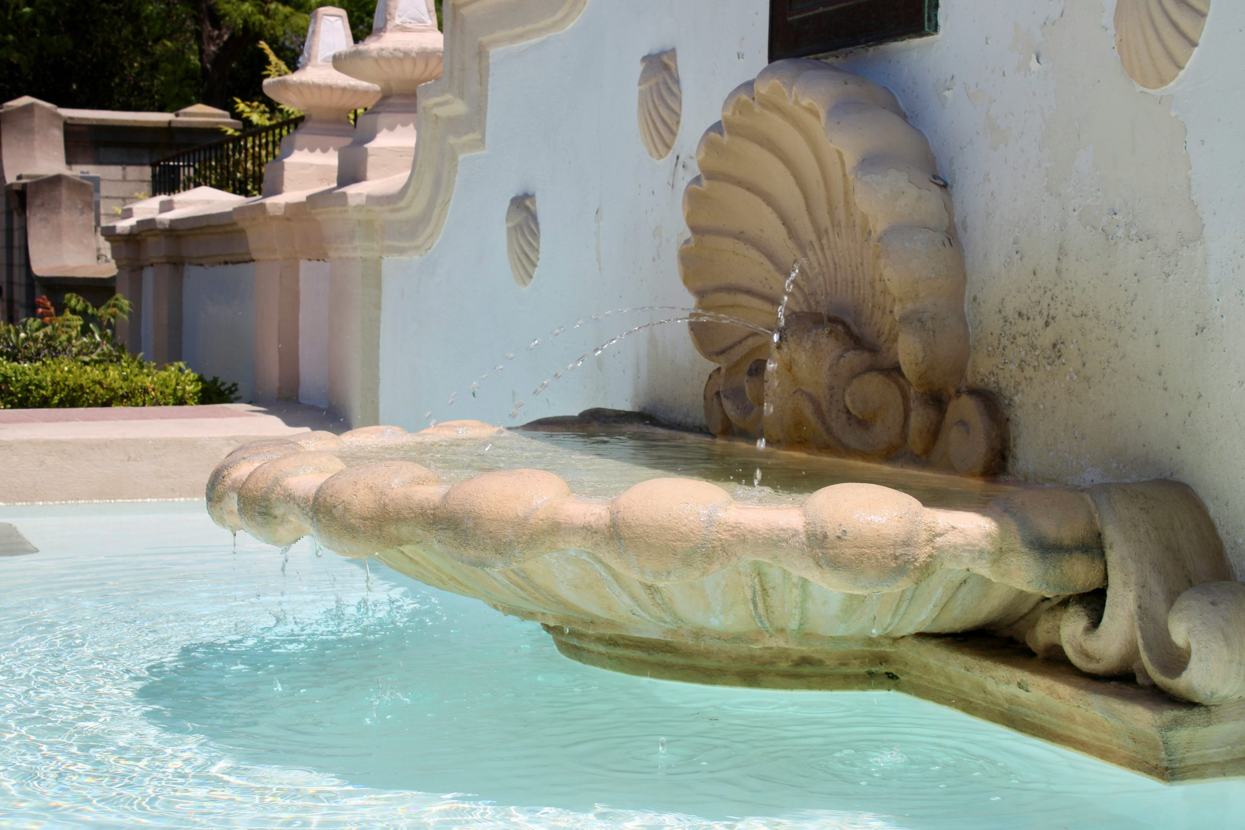 High angle shot of a luxury patio made of beige natural stone with pool border detail under sunlight