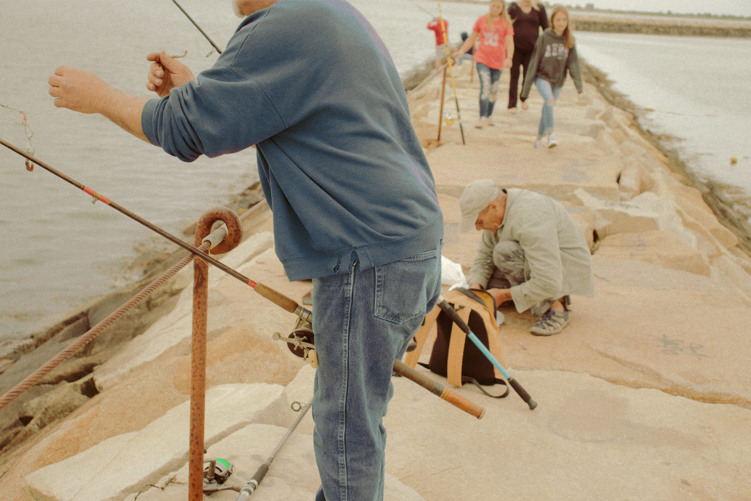 Worker inspecting a finished granite slab with a light to check for imperfections