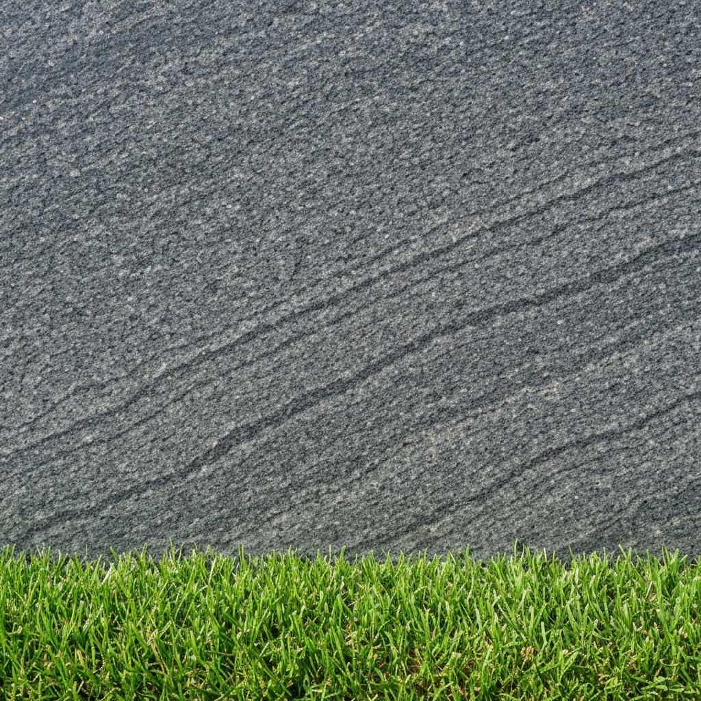 Close up detail of Prestance dark grey granite texture with green grass border