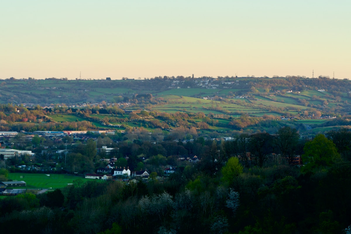 A scenic view of green hills and buildings.