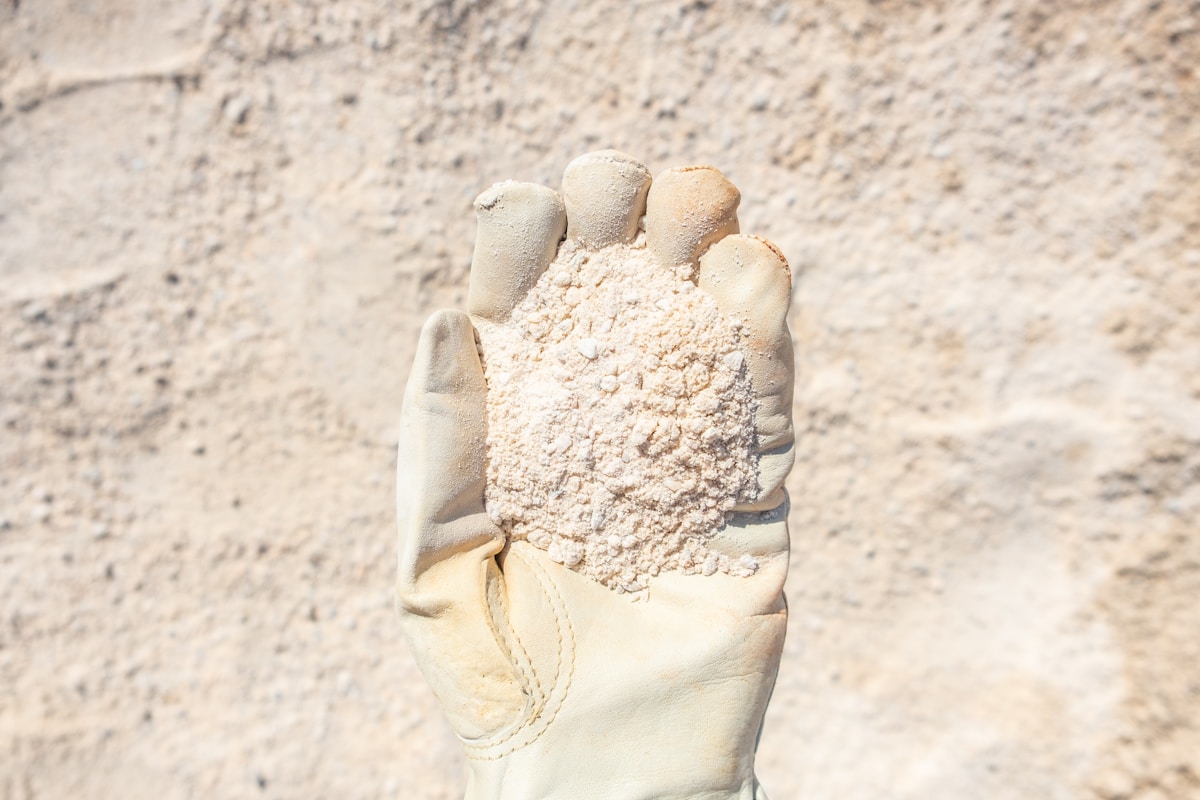 person wearing white gloves with white powder