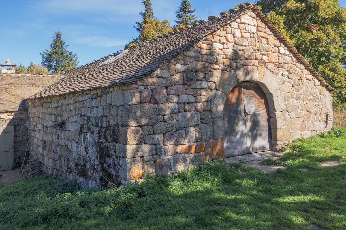 Old stone building with arched wooden door