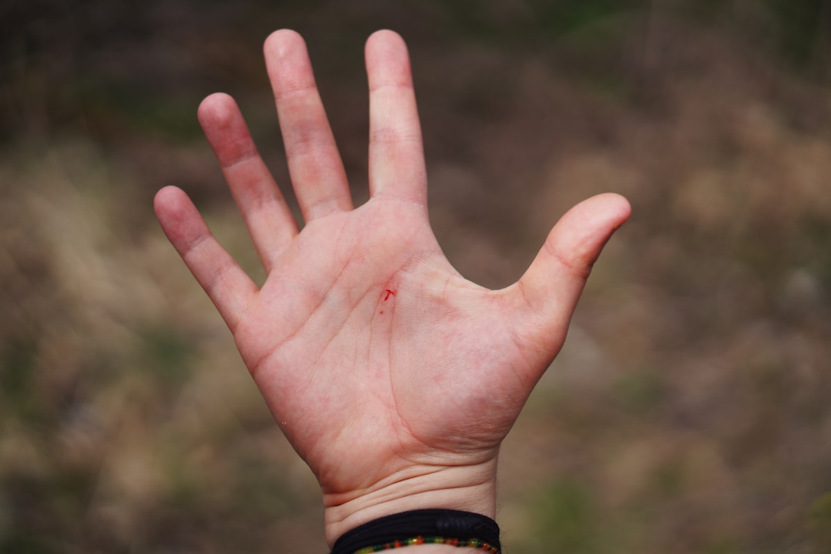 person in black leather strap watch showing left palm