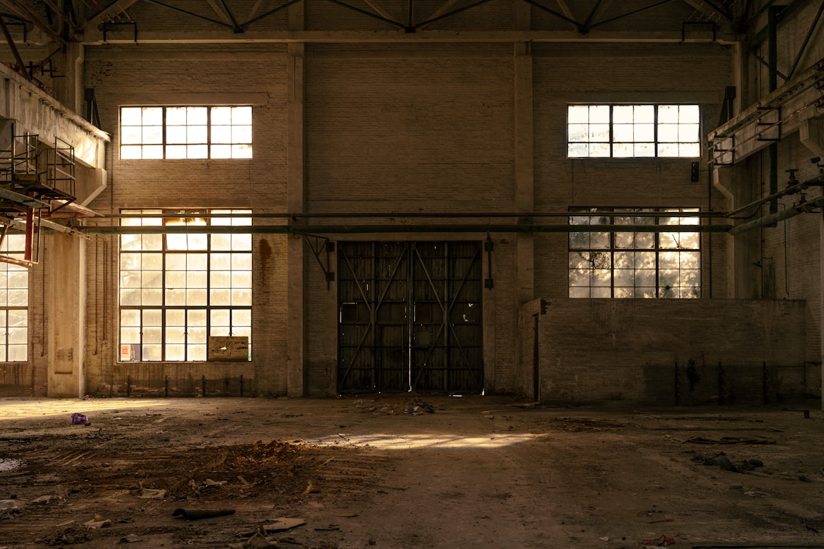 Abandoned industrial building interior with large windows