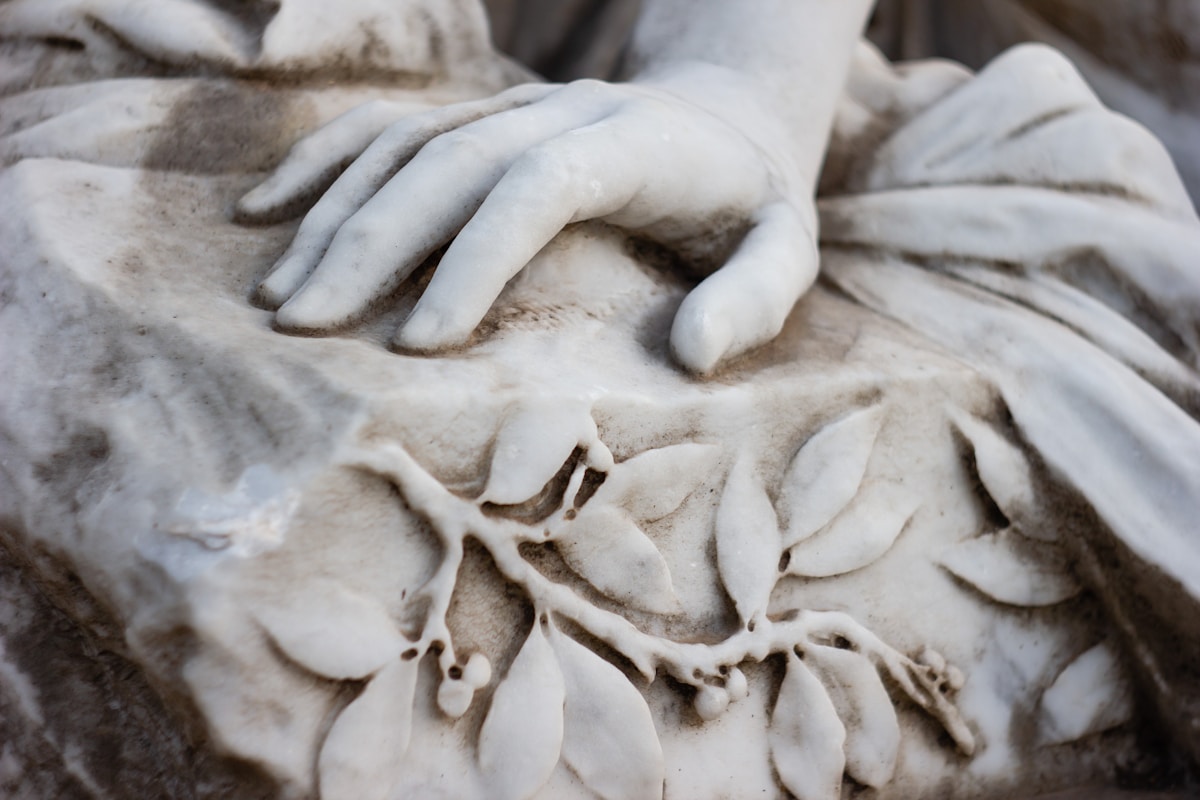 A close up of a statue of a woman with her hands on her chest