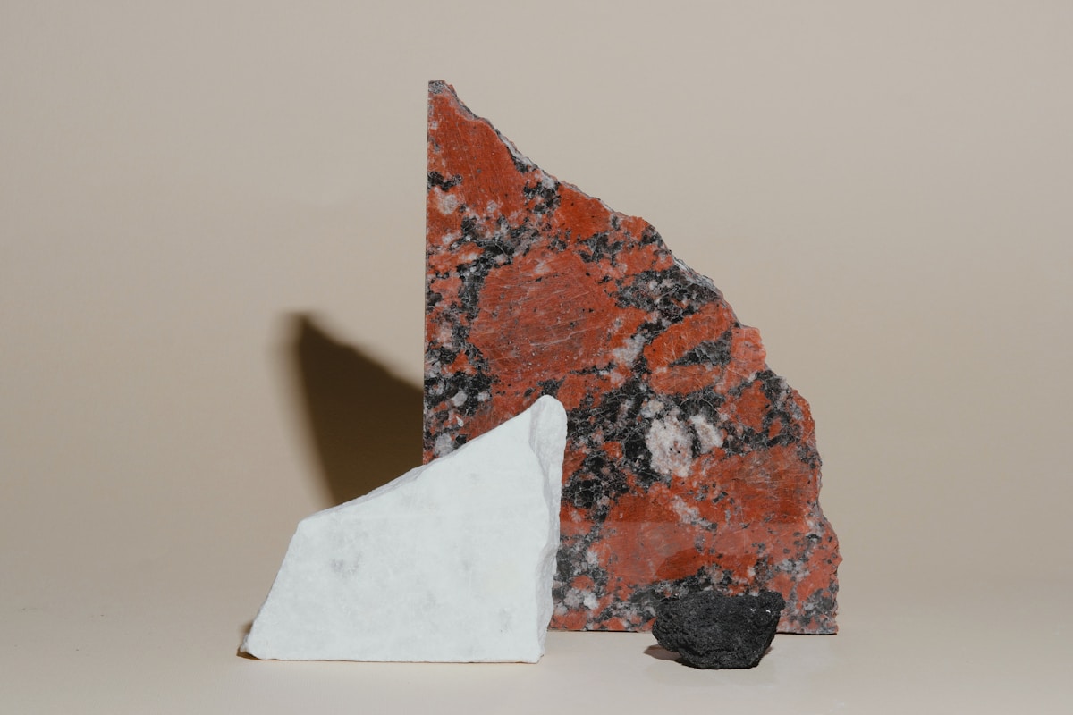 Three rock samples on a plain background