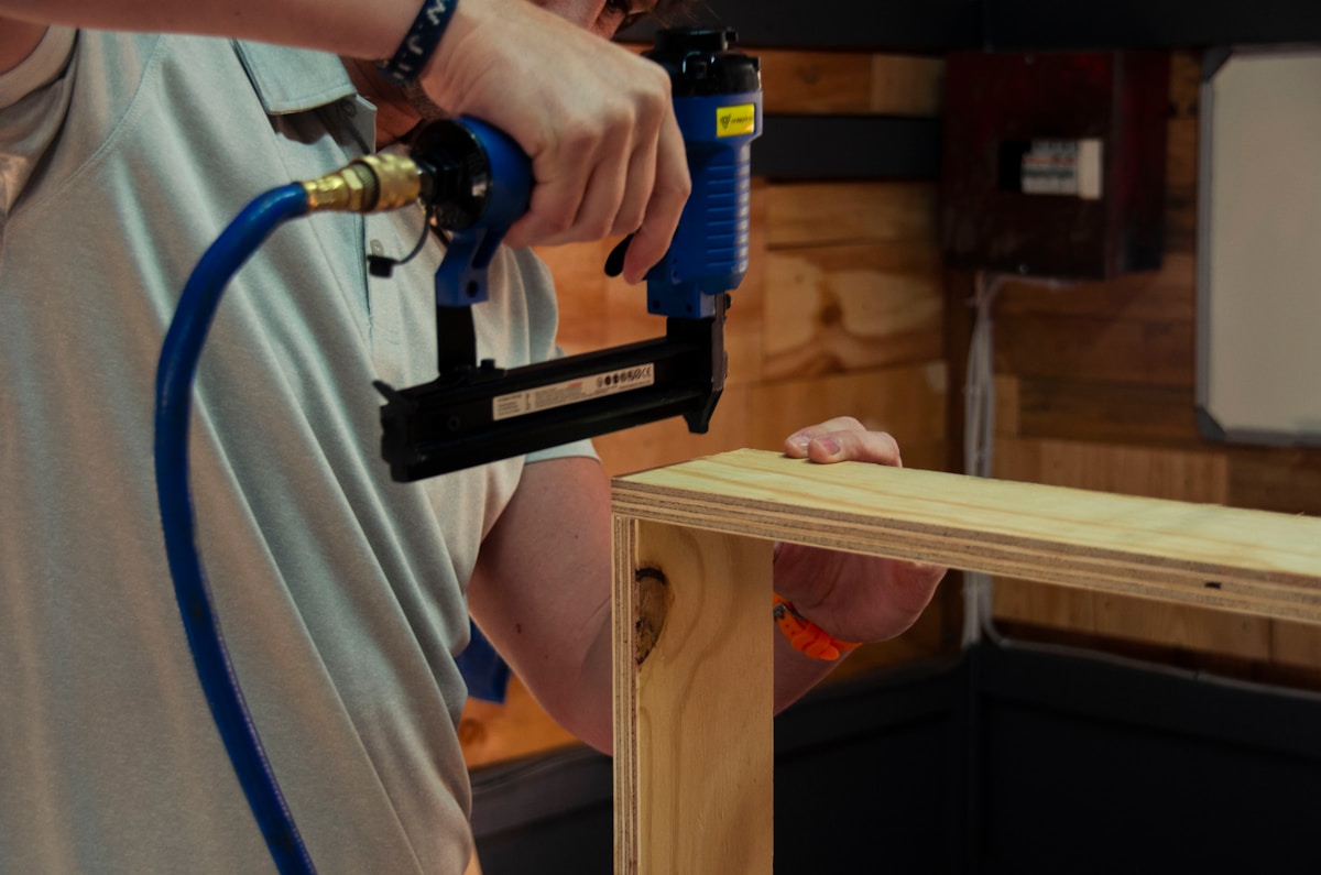 a man using a power drill on a piece of wood