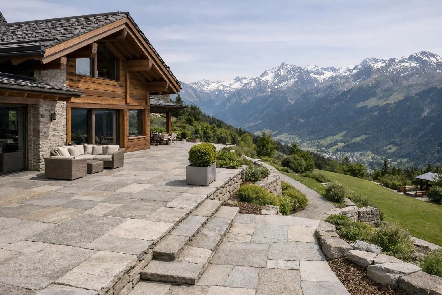 Luxurious Swiss mountain home with natural stone patio and pathways leading to garden, showcasing granite or limestone pavers in shades of gray and beige, with Alpine landscape in background, professional architectural photography style capturing durability and timeless elegance