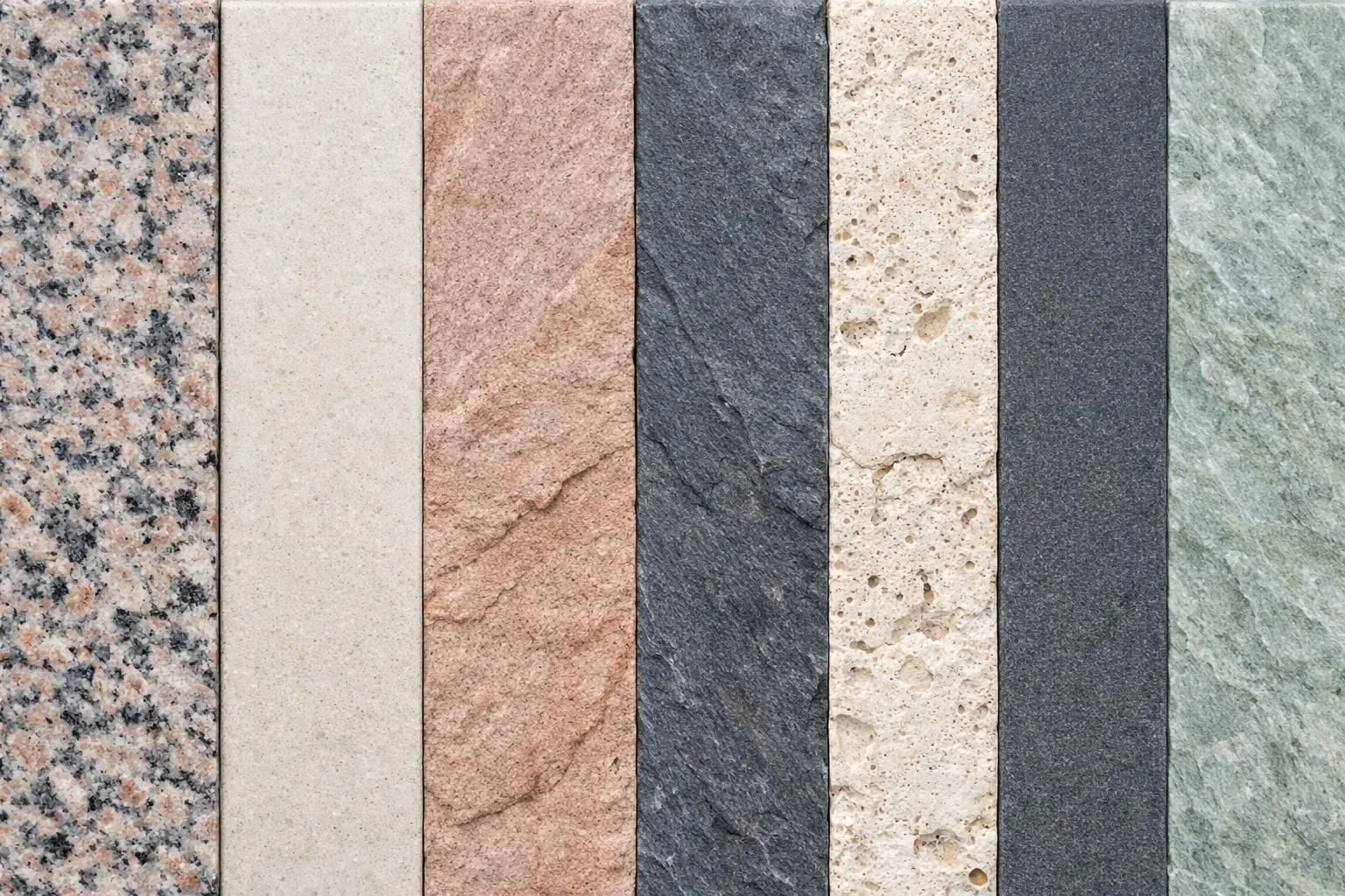 Close-up display of seven different natural stone samples arranged side by side showing various textures and colors including granite, limestone, sandstone, slate, travertine, basalt and quartzite for wall coping applications