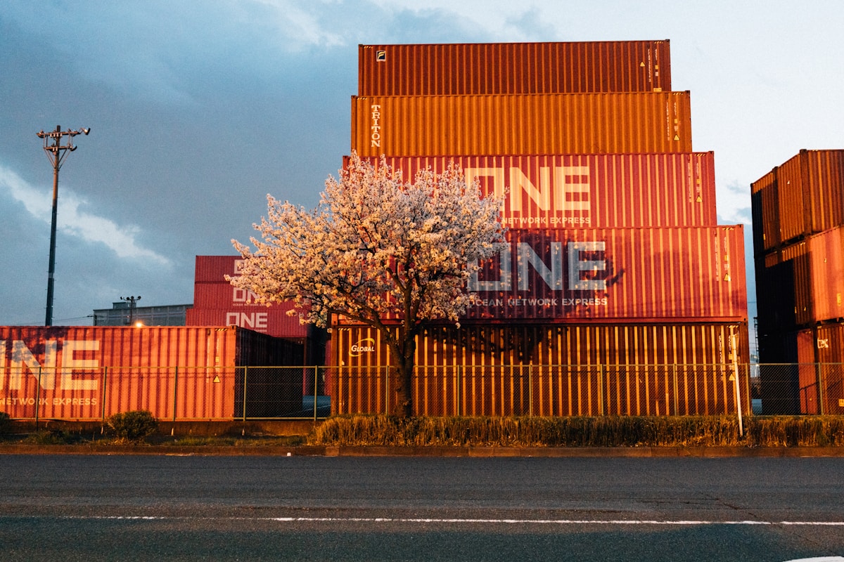 Stack of orange shipping containers with 'one' logo.