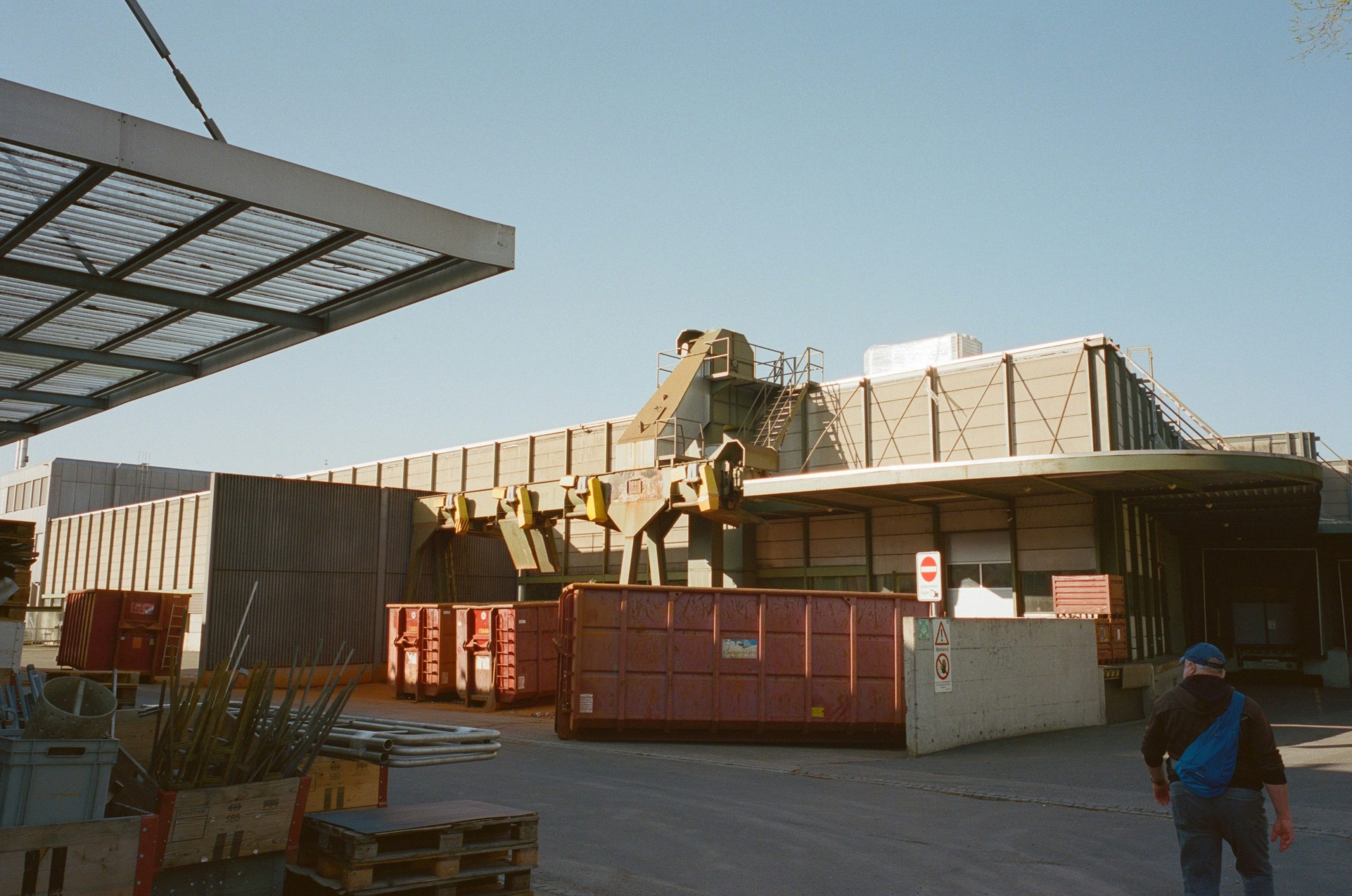 delivery truck with crane unloading stone crates at a construction site in switzerland