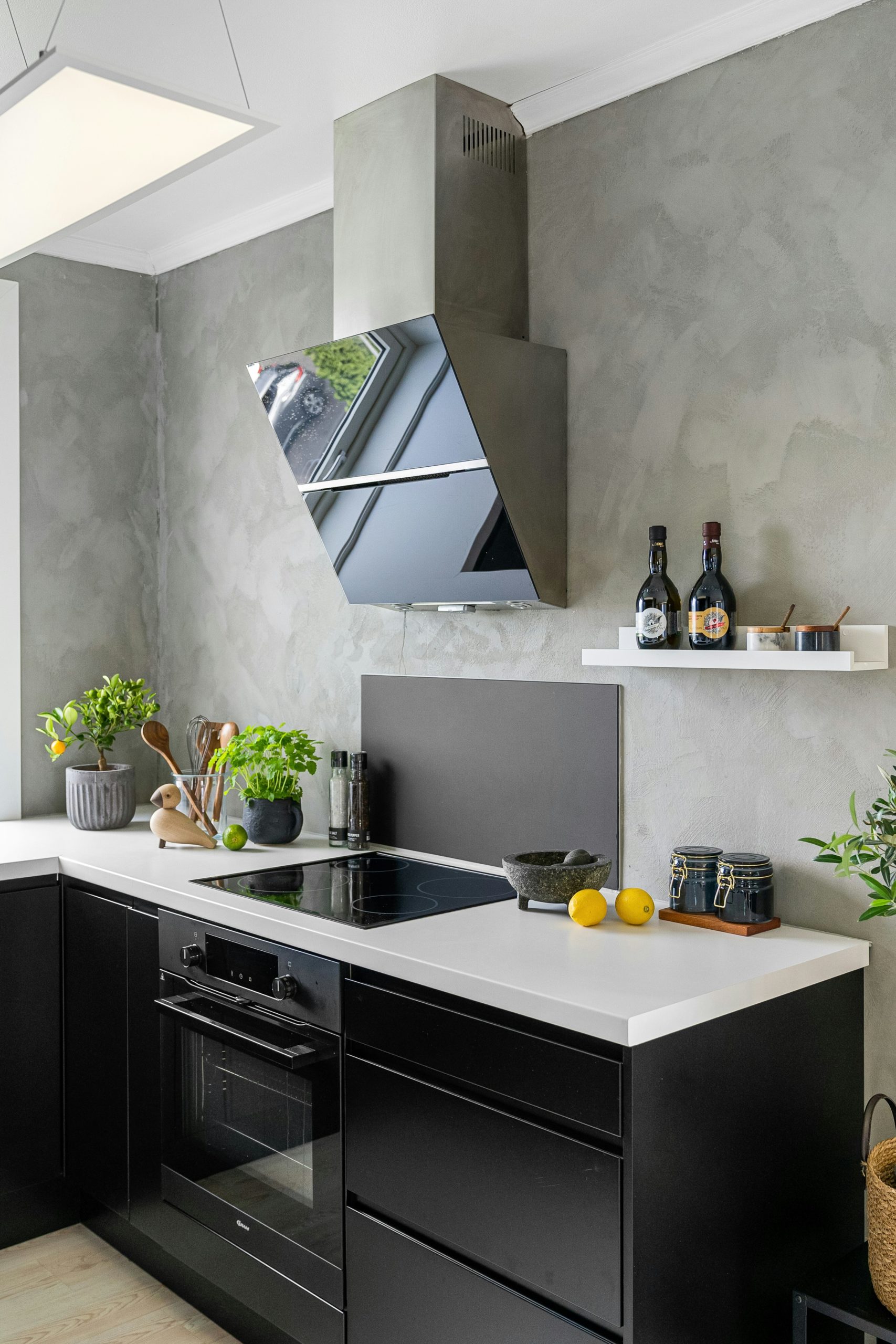 Modern kitchen interior with black granite countertop and light grey cabinets