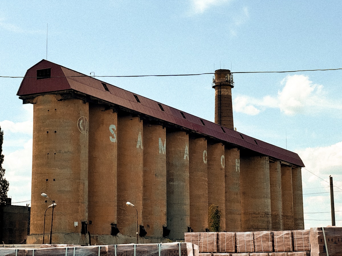Bâtiment industriel en briques rouges avec une cheminée.
