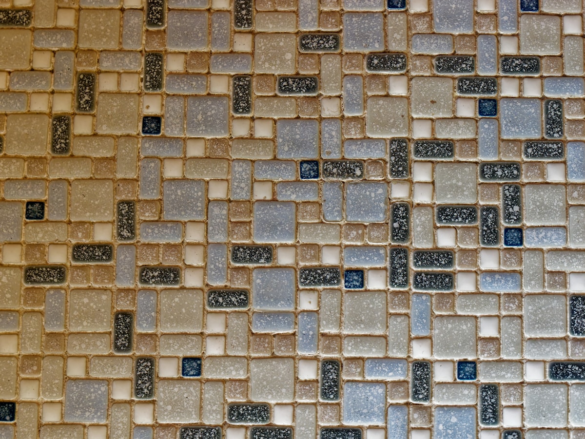 a close up of a wall made of small tiles