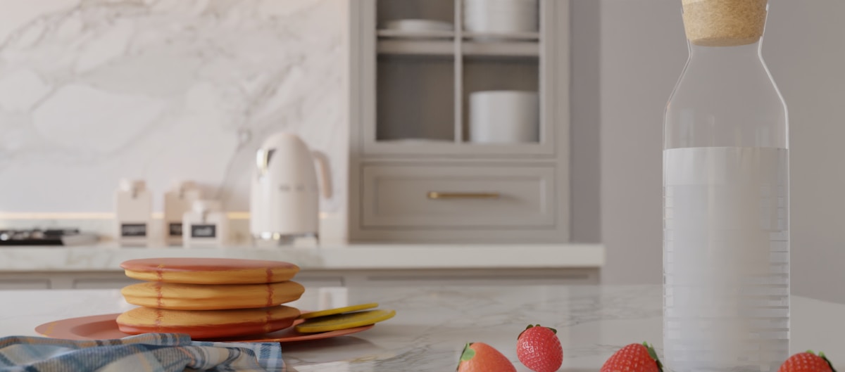 Cuisine moderne avec vaisselle, fruits et électroménagers.
