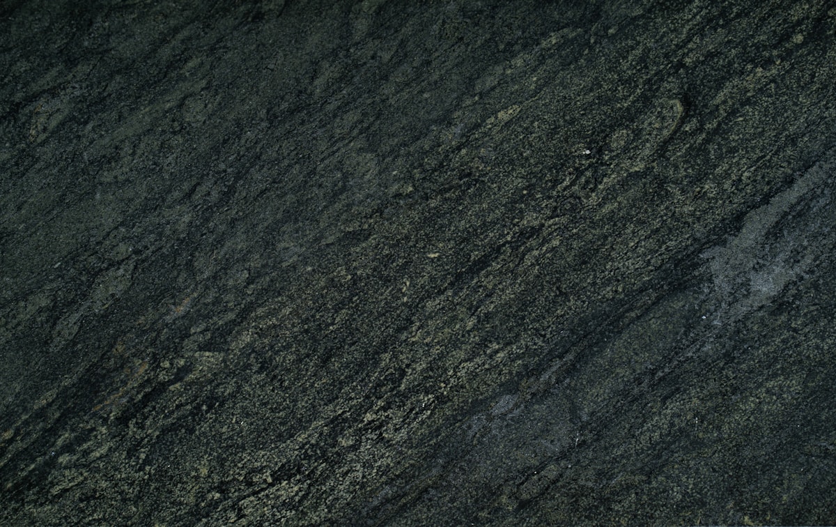 Texture de roche sombre et rugueuse avec des veines.
