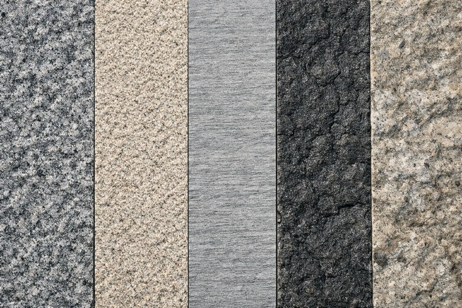 Échantillons de différentes textures de pierre, allant du granit clair au basalte foncé.