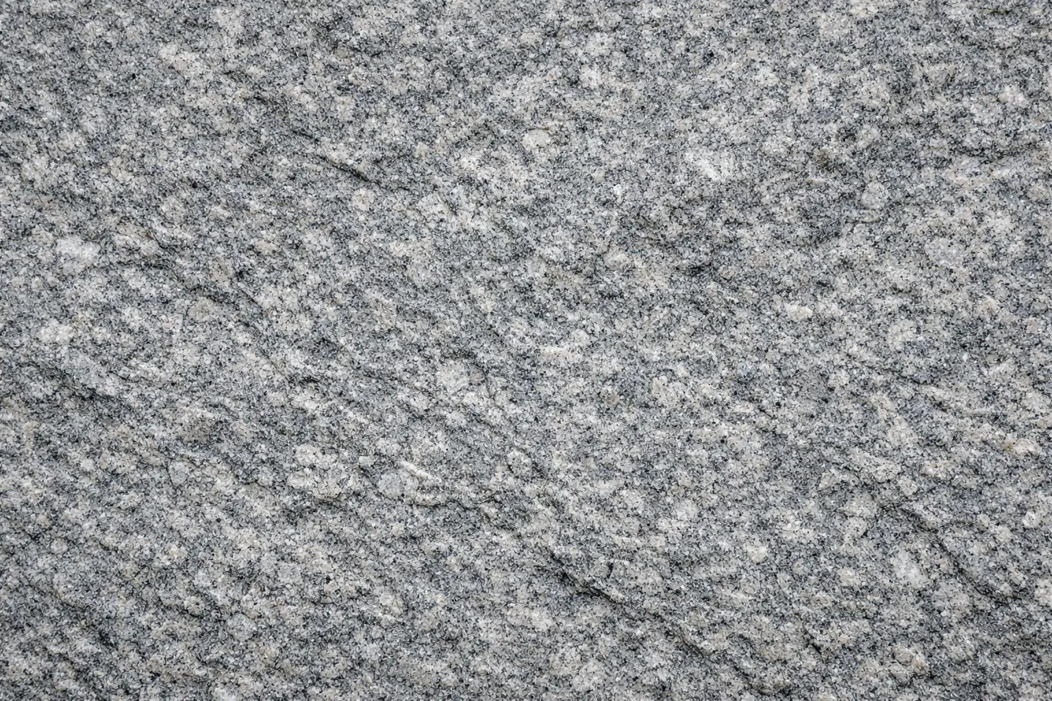 Texture de granit gris avec des motifs irréguliers.